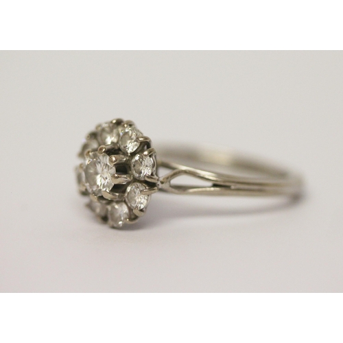 620 - A diamond circular cluster ring, on hallmarked 18ct white gold band. Ring size M