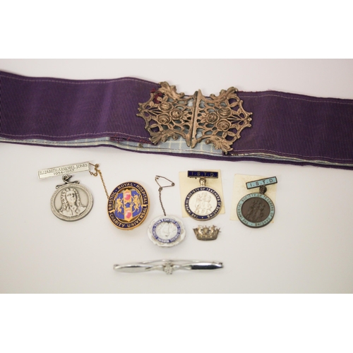 623 - A nurse belt and buckle, various presentation badges & medallions, RAF wings badge and a silver cres... 