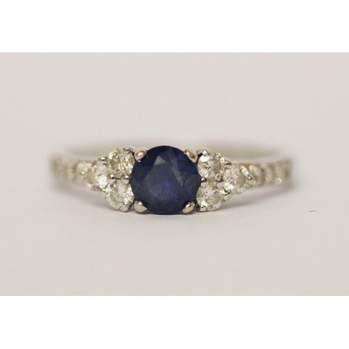 624 - A modern sapphire and diamond cluster ring, on 18ct white gold band. Marked 750 18K, ring size N