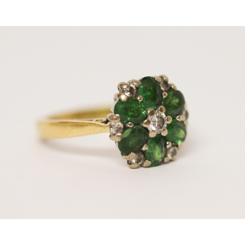 628 - An emerald and diamond cluster ring, on 18ct yellow gold band. Hallmarked, ring size J