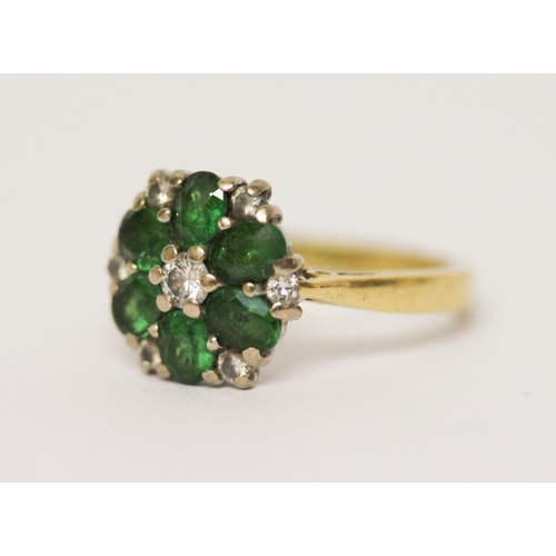 628 - An emerald and diamond cluster ring, on 18ct yellow gold band. Hallmarked, ring size J