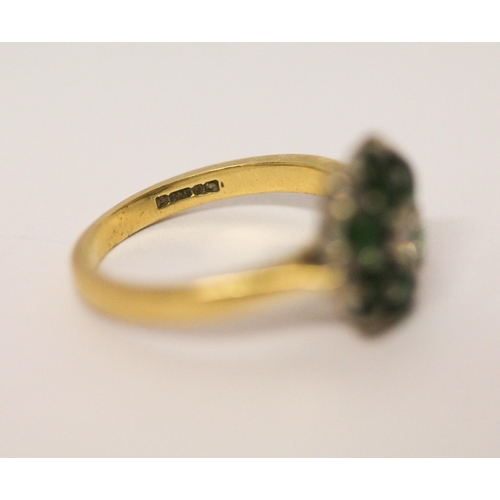 628 - An emerald and diamond cluster ring, on 18ct yellow gold band. Hallmarked, ring size J