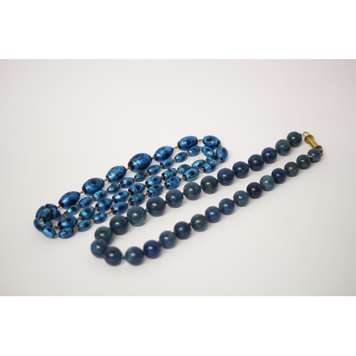 635 - A row of vintage Murano peacock glass beads and a row of lapis beads with gilt metal filigree clasp