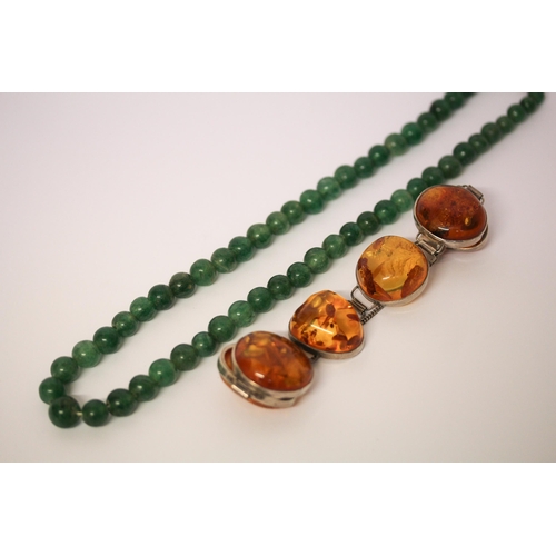 641 - A modern chunky amber and silver link bracelet, clasp marked 925, together with a row of jade beads.