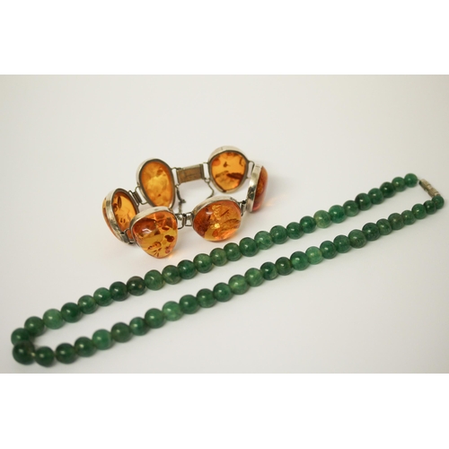 641 - A modern chunky amber and silver link bracelet, clasp marked 925, together with a row of jade beads.