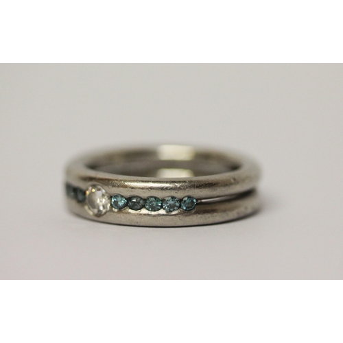 647 - Modern platinum and diamond band, set with white and blue diamonds, hallmarked, ring size L. Gross w... 