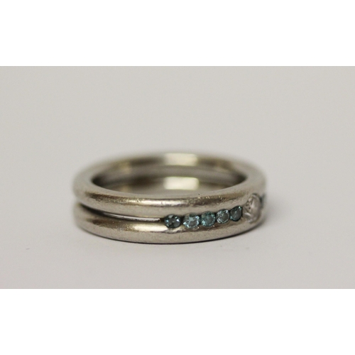 647 - Modern platinum and diamond band, set with white and blue diamonds, hallmarked, ring size L. Gross w... 