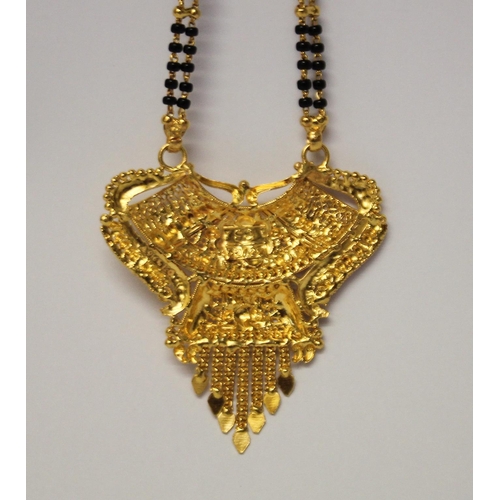 655 - Indian high carat gold fringe pendant necklace, the ornate pendant suspended from gold and onyx bead... 