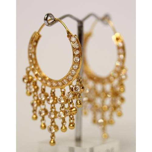 656 - A pair of Indian yellow gold tasselled creole hoop earrings, set with white stones. Gross weight 13.... 