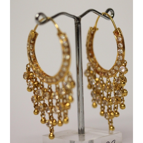 656 - A pair of Indian yellow gold tasselled creole hoop earrings, set with white stones. Gross weight 13.... 