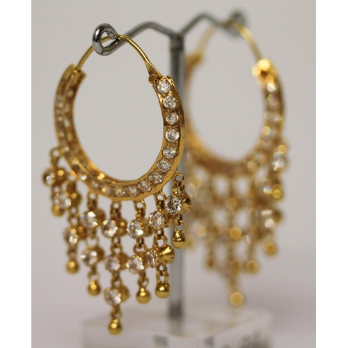 656 - A pair of Indian yellow gold tasselled creole hoop earrings, set with white stones. Gross weight 13.... 