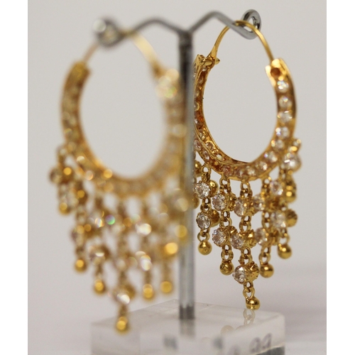 656 - A pair of Indian yellow gold tasselled creole hoop earrings, set with white stones. Gross weight 13.... 