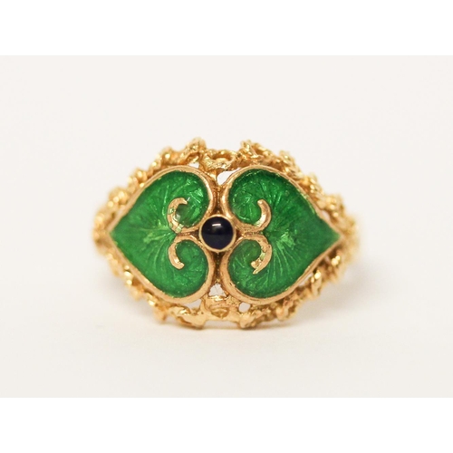 657 - Indian yellow gold dress ring with green enamel decoration, shank marked 750. Ring size M