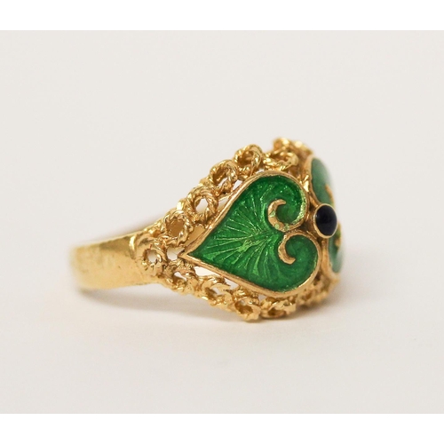 657 - Indian yellow gold dress ring with green enamel decoration, shank marked 750. Ring size M