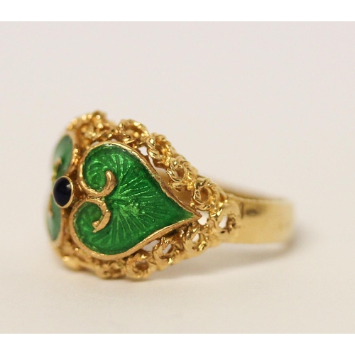 657 - Indian yellow gold dress ring with green enamel decoration, shank marked 750. Ring size M