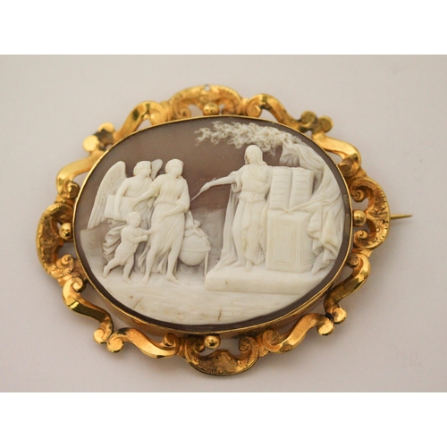 662 - An antique  large oval shell cameo carved with classical scene in openwork yellow gold mount. Unmark... 