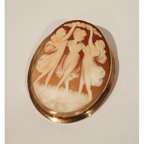 666 - An Italian carved shell cameo brooch - The Three Graces,  in 14k yellow gold oval mount. 5.5 cms