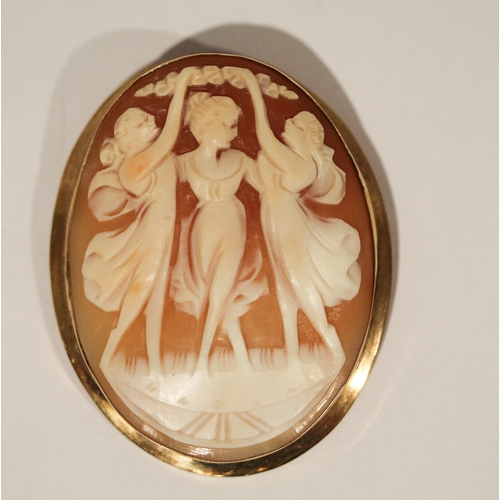 666 - An Italian carved shell cameo brooch - The Three Graces,  in 14k yellow gold oval mount. 5.5 cms