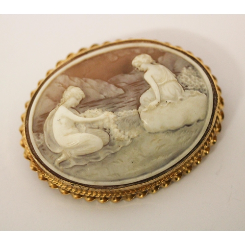 668 - An oval carved shell cameo depicting two nymphs by a lake, in hallmarked 9ct gold frame, 6cms approx