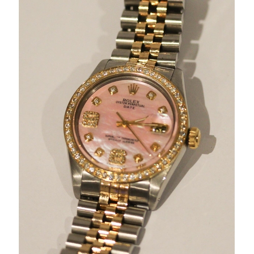 669 - A Rolex Oyster perpetual date wristwatch with retro fit diamond bezel, diamond numerals and pink mot... 