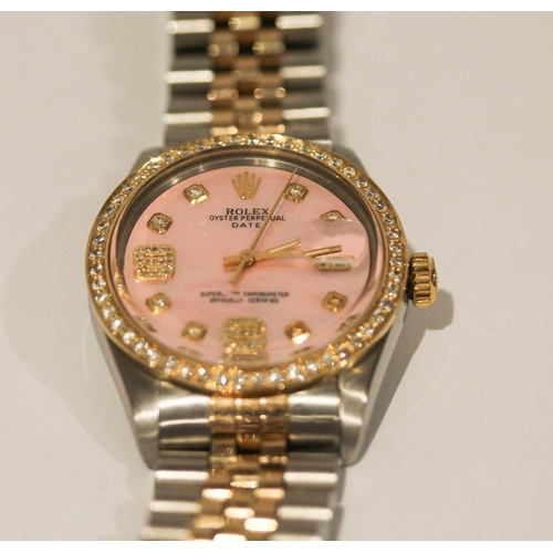 669 - A Rolex Oyster perpetual date wristwatch with retro fit diamond bezel, diamond numerals and pink mot... 