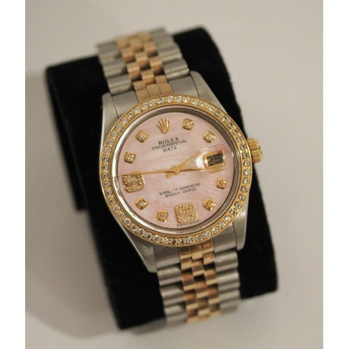 669 - A Rolex Oyster perpetual date wristwatch with retro fit diamond bezel, diamond numerals and pink mot... 