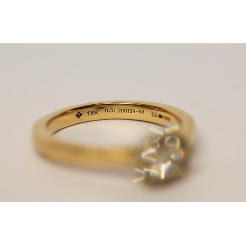 679 - A diamond cluster ring on an 18ct yellow gold shank, hallmarked, diamond weight 51 pts marked in sha... 