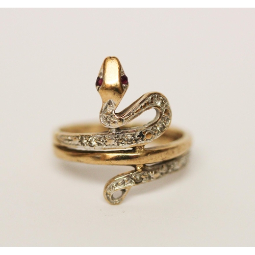 690 - A 9ct gold diamond set snake ring with ruby eyes, hallmarked, size M