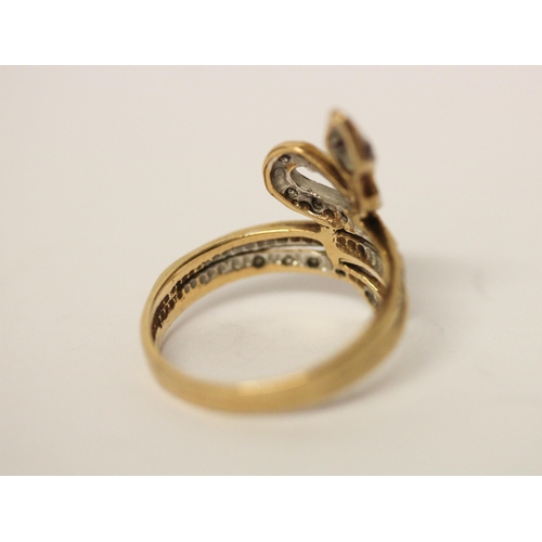 690 - A 9ct gold diamond set snake ring with ruby eyes, hallmarked, size M