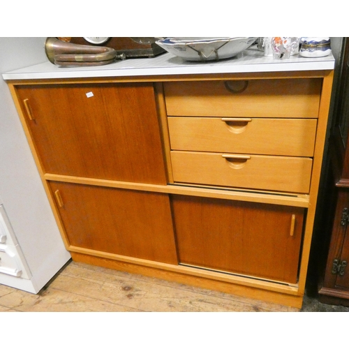 346 - A teak kitchen side cabinet with sliding doors and fitted drawers with Formica top, 3'6 wide