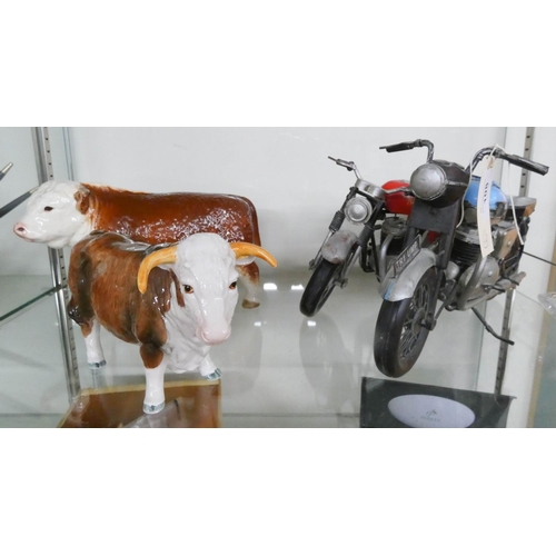 108 - Two china models of Hereford bulls and two vintage style model motorcycles