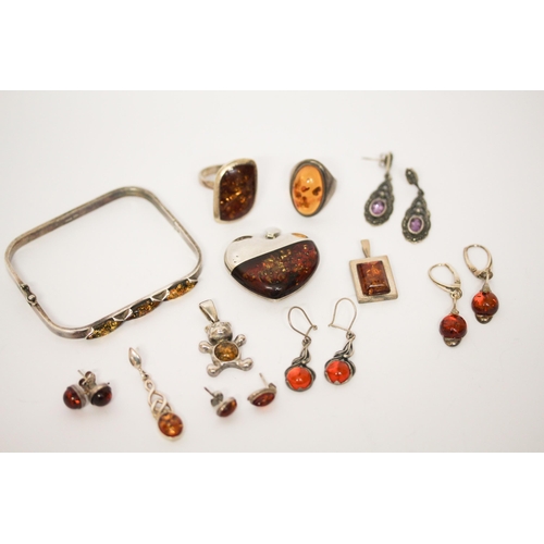 698 - A collection of silver and amber jewellery to include a bangle