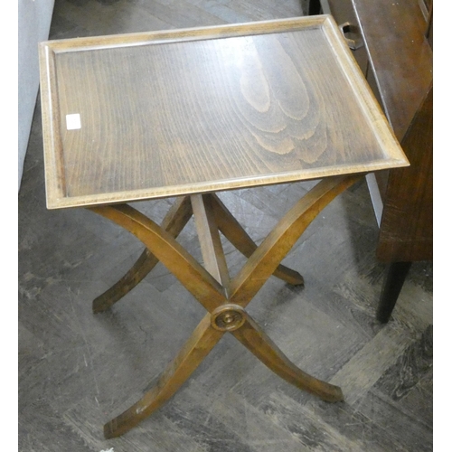 130 - An occasional table with tray top on a cross stretcher base