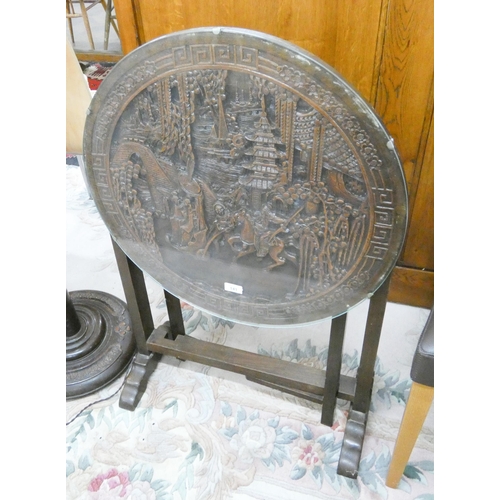 141 - A carved Chinese occasional table come fire screen with glass top, 2' diameter