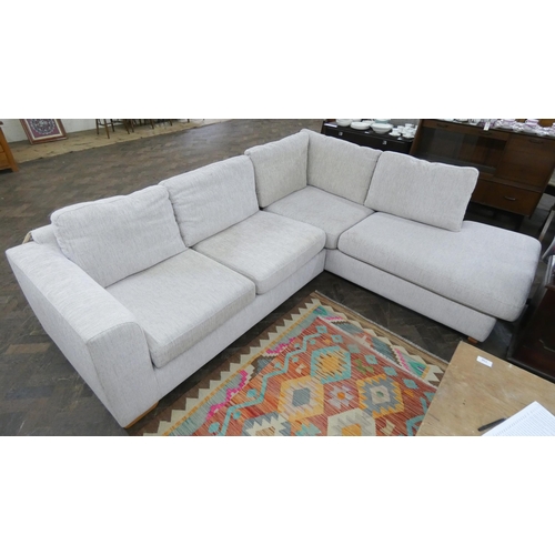 146 - A modern corner settee unit with loose cushions in a fawn mottled covering