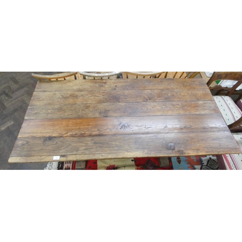 153 - A French oak refectory style plank top dining table, 63