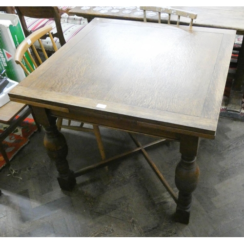 216 - An oak draw leaf dining table with bulbous legs and cross stretchers, 3' square