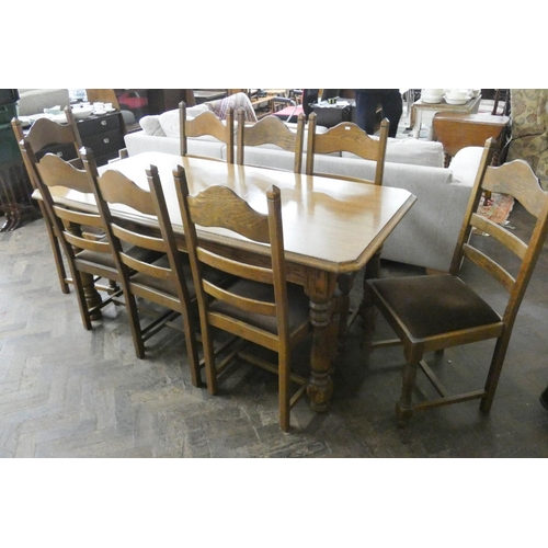 222 - An oak dining table on turned legs, 5'6 x 2'9 together with eight matching ladder back dining room c... 