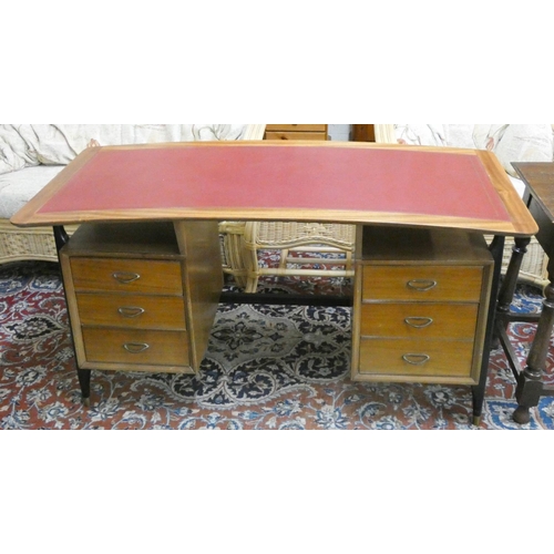 259 - A mid-century curved desk fitted six drawers with red leather top, on black tapering legs. 55