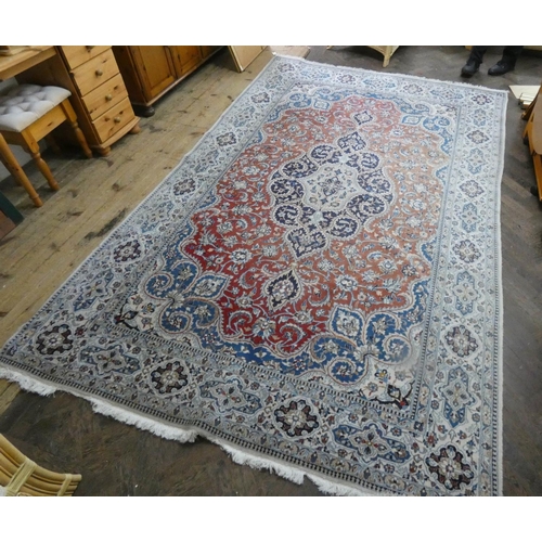 261 - A fawn and patterned Persian design wool pile rug, 11' x 6'9