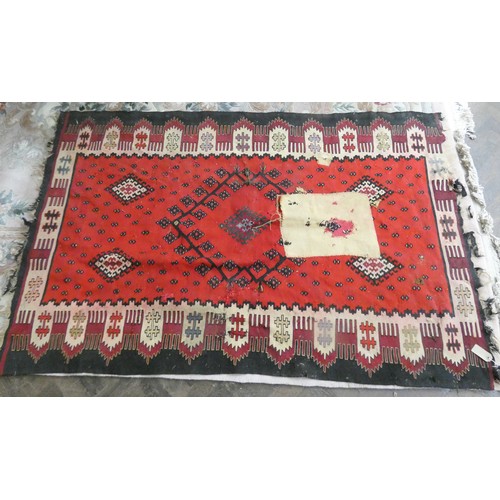 151 - A large red and patterned Kilim style rug, 77