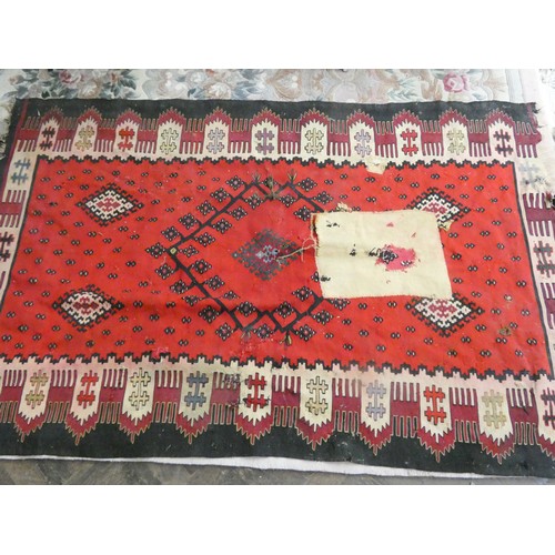 151 - A large red and patterned Kilim style rug, 77