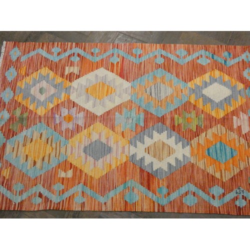 159 - An orange and patterned wool pile Kilim style rug, 4'3 x 2'8