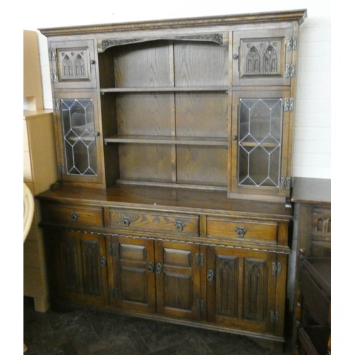 279 - A reproduction oak dresser with leadlight glazed and shelf cabinet back on a drawer and cupboard bas... 