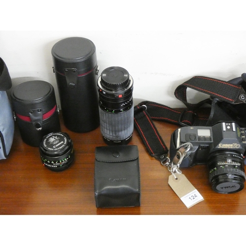 124 - A Cannon T70 camera with three various lenses, carrying bag etc