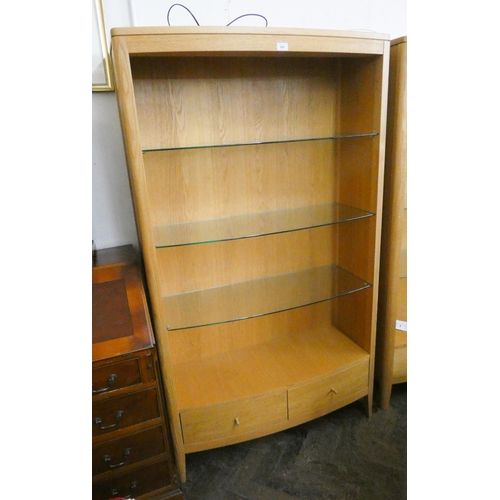 264 - A modern bow front light oak open bookcase/display cabinet with glass shelves and two drawers under ... 