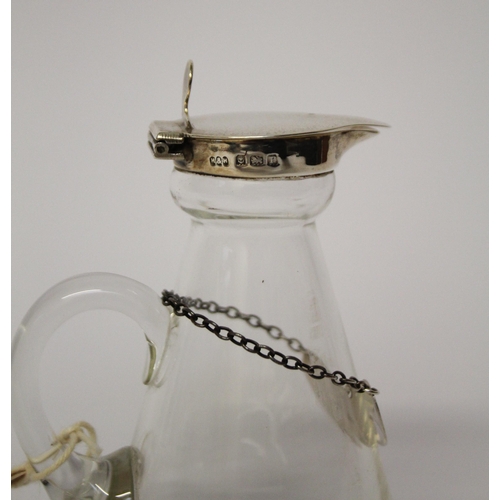 508 - A whisky tot with silver lid and silver decanter label