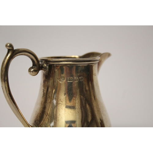 521 - A silver cream jug of plain form, Goldsmiths & Silversmiths Co,  London marks 1928, 4.75 troy ounces... 