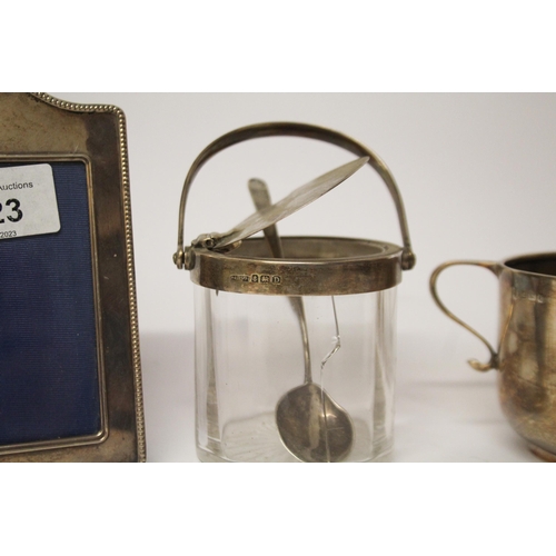 523 - A small silver photograph frame, a silver sugar basin and a Asprey silver topped patented preserve j... 