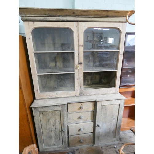 37 - A Victorian stripped pine kitchen dresser with glazed cabinet back standing on a drawer and cupboard... 